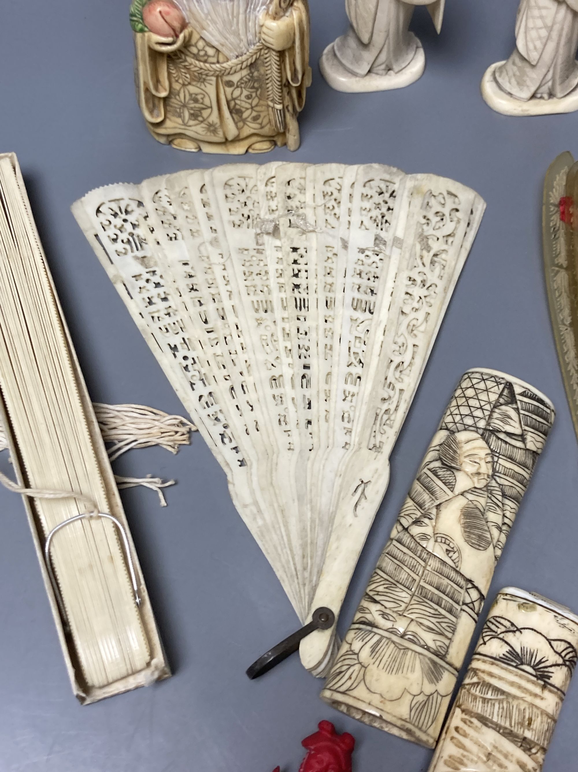 A quantity of bone and ivory carvings including fans and figures